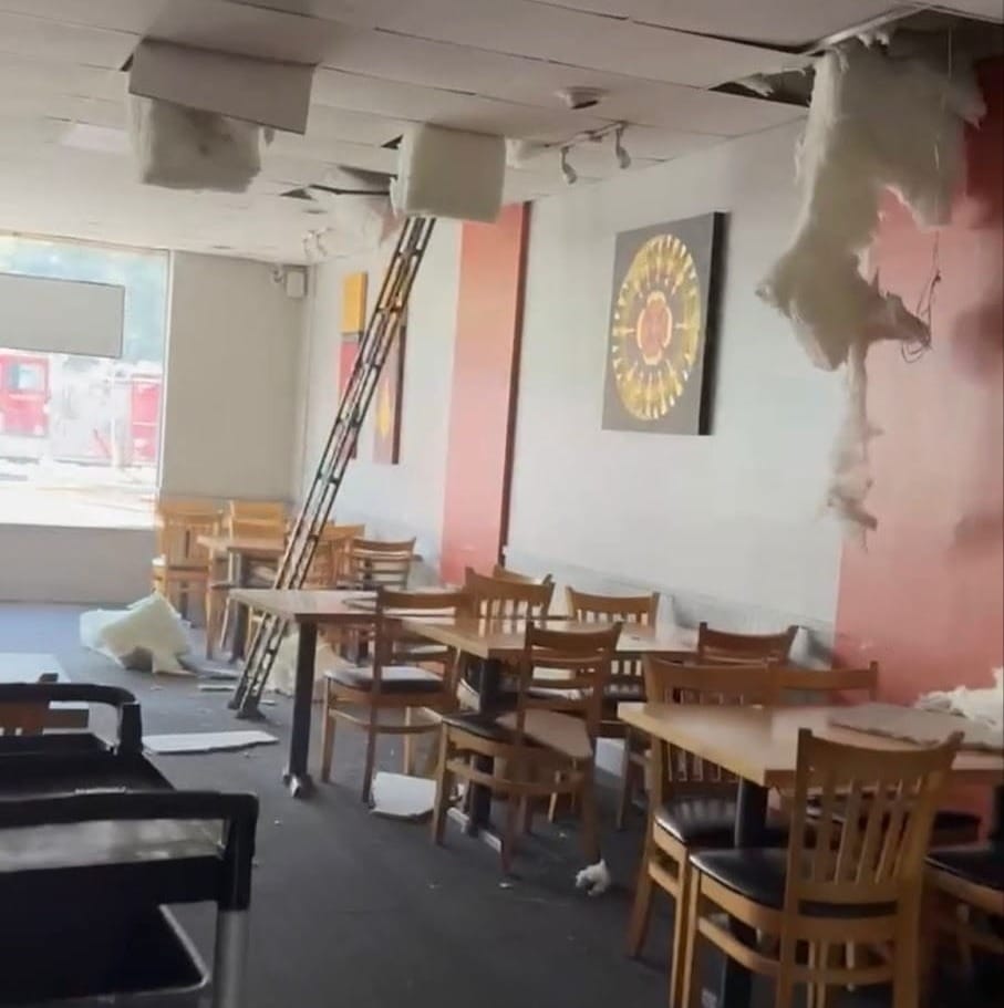 Photograph of damaged ceiling and walls inside Red Chili after the fire.