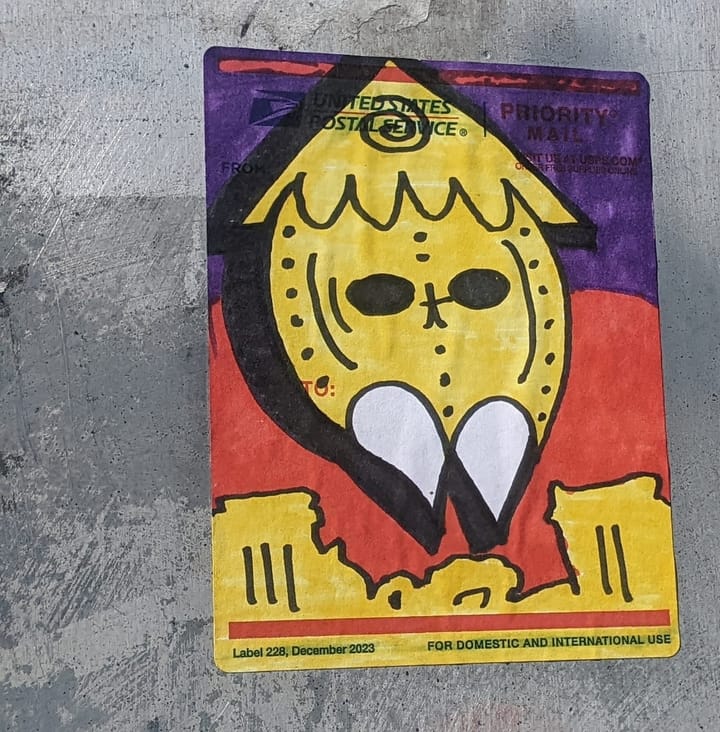 Photograph of a decorated shipping label with a strange illustration. 